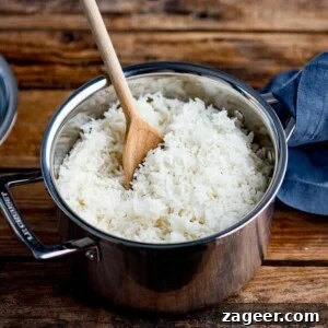 Perfectly Cooked Rice: Step-by-Step Guide for Fluffy Grains 7 Wooden spoon in a pan of boiled rice
