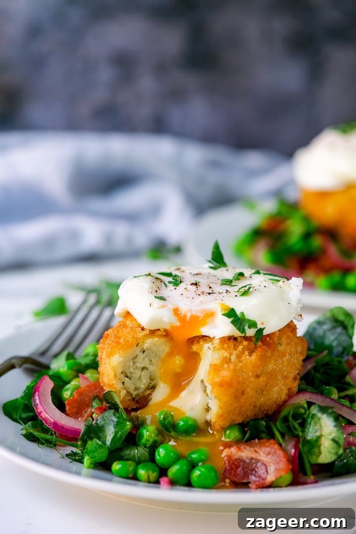 pea and bacon salad topped with a fish cake and poached egg on a light background