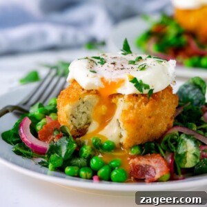 pea and bacon salad topped with a fish cake and poached egg that have been cut into.