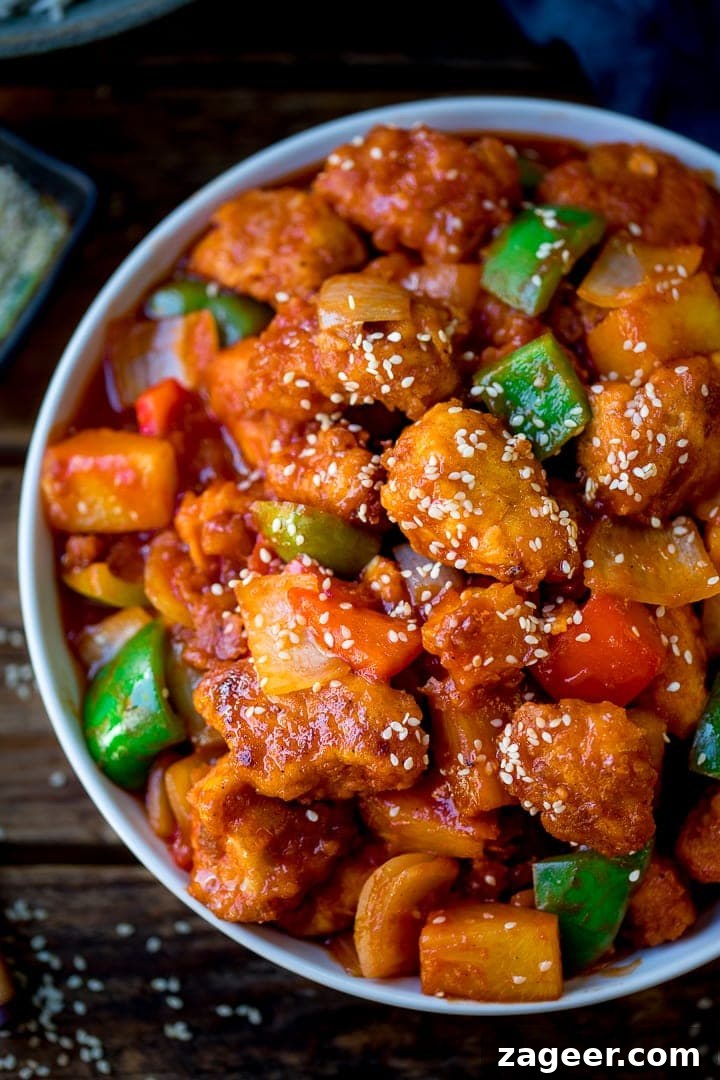 Authentic Sweet and Sour Chicken Recipe for Sticky, Tangy Sauce 2 Close up of sweet and sour chicken in a bowl