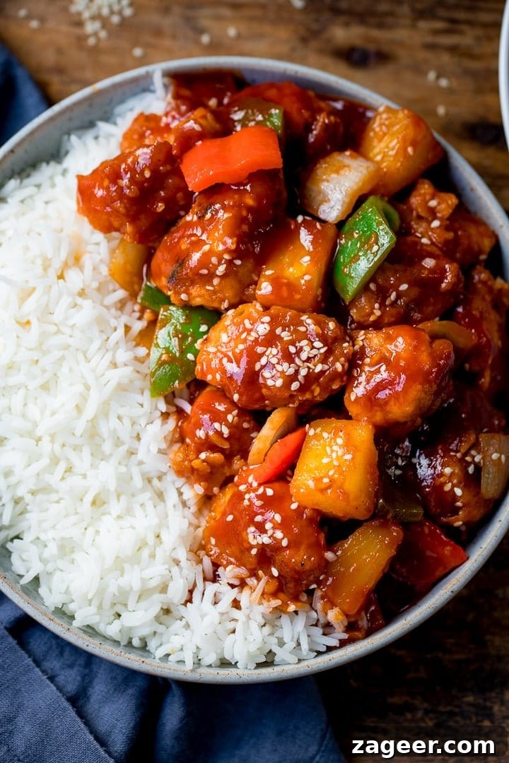 Authentic Sweet and Sour Chicken Recipe for Sticky, Tangy Sauce 14 Sweet and sour chicken in a bowl with rice