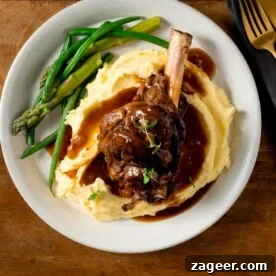 Top Slow Cooker Recipes for Flavorful Weeknight Meals 4 Slow cooked lamb shank on mashed potato with green beans and asparagus