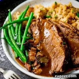 Top Slow Cooker Recipes for Flavorful Weeknight Meals 9 Plate of sliced roast beef with vegetables and gravy