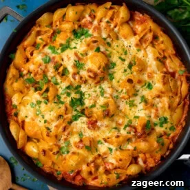 Pantry-Friendly Recipes: Delicious Meals from Store Cupboard Staples 4 Overhead image of a creamy tuna tomato pasta bake topped with melted cheese and chopped parsley