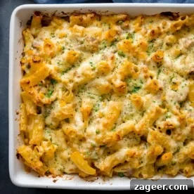 Pantry-Friendly Recipes: Delicious Meals from Store Cupboard Staples 7 Overhead image of tuna pasta bake in a white dish topped with finely chopped parsley