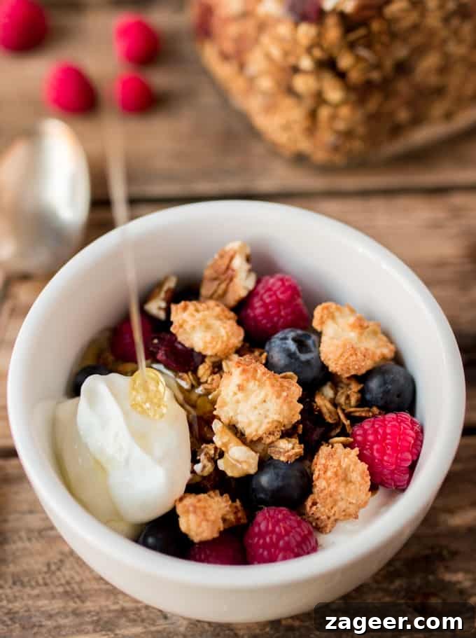 Coconut Macaroon Granola Recipe — Crunchy Toasted Coconut Clusters 3 Bowl of Coconut Macaroon Granola with Greek yogurt and honey being poured onto