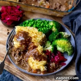 Cottage pie on a plate with vegetables