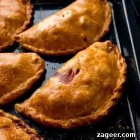 Cornish pasties on a black baking tray