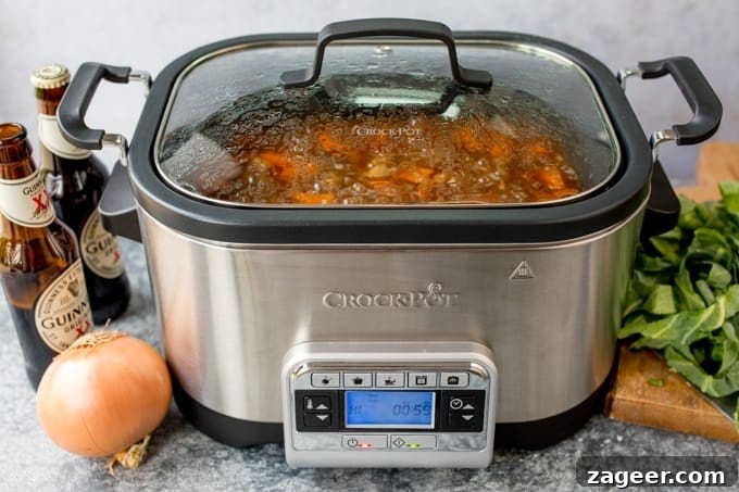 Hearty Beef and Guinness Stew Topped with Crispy Fried Onions 3 Crockpot with beef stew. Onions, Guinness and cabbage on the table.