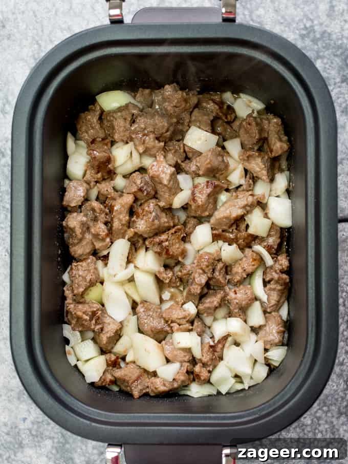 Hearty Beef and Guinness Stew Topped with Crispy Fried Onions 7 Crockpot filled with seared beef and onions