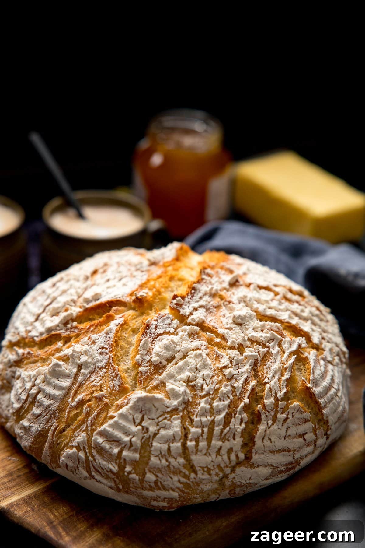 Authentic Artisan Bread Recipe: Simple Sourdough & Crusty Loaf Guide 2 Artisan bread on a wooden board against a dark background