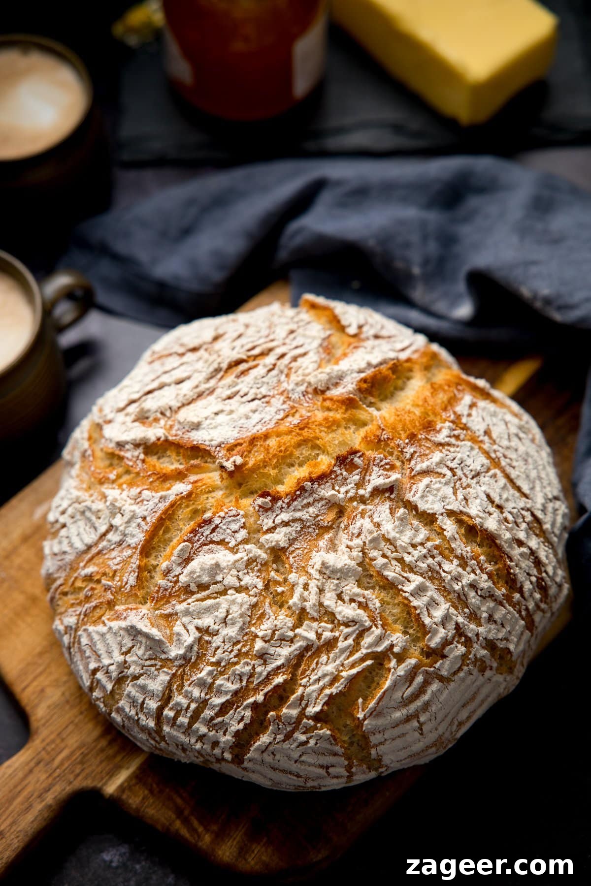 Authentic Artisan Bread Recipe: Simple Sourdough & Crusty Loaf Guide 7 Overhead image of a loaf of homemade artisan bread on a wooden board
