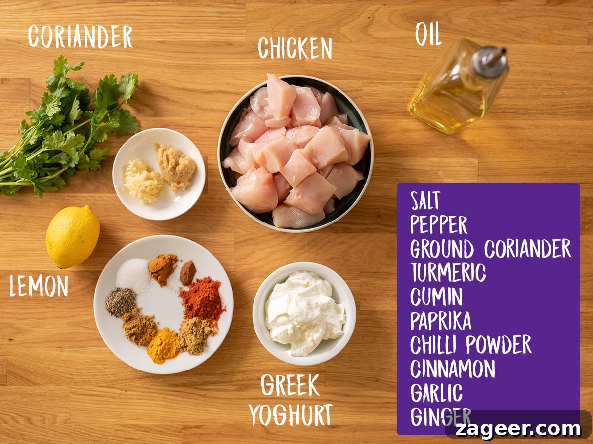 Ingredients for chicken tikka skewers on a wooden board