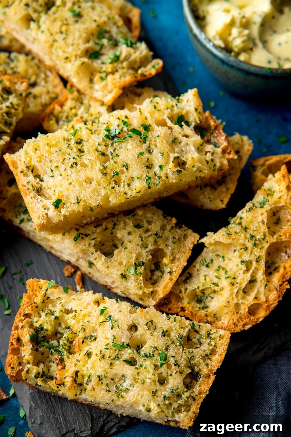 Quick Homemade Garlic Bread Recipe for Crispy, Flavorful Slices 2 Slices of garlic bread on a piece of slate