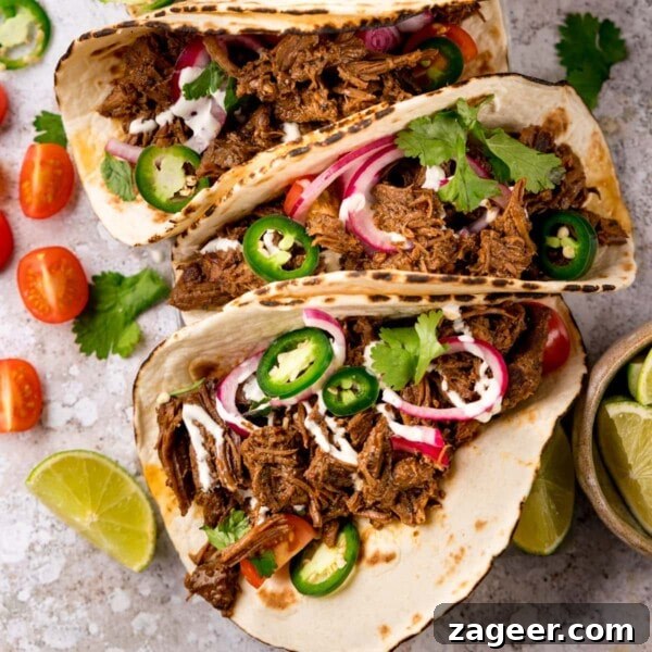 Authentic Lamb Barbacoa Recipe — Slow-Cooked Mexican-Style Lamb 12 Square image of beef barbacoa on soft tacos topped with red onion and jalapeno slices