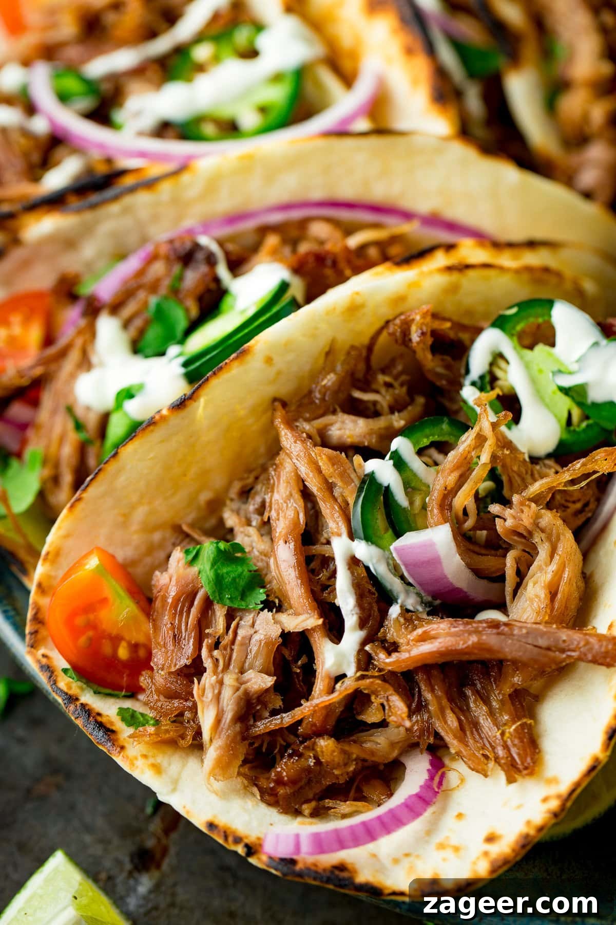 Authentic Lamb Barbacoa Recipe — Slow-Cooked Mexican-Style Lamb 14 Close up of Lamb Barbacoa Carnitas Tacos with sour cream and red onions