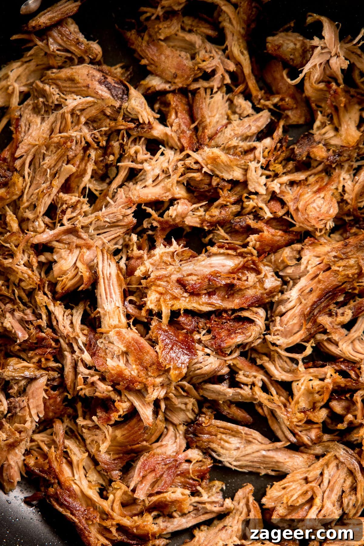 Authentic Lamb Barbacoa Recipe — Slow-Cooked Mexican-Style Lamb 6 Shredded lamb carnitas in a frying pan