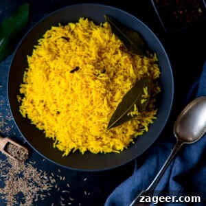 Authentic Pilau Rice Recipe: Aromatic Spiced Pilaf Instructions 8 Square image of Pilau rice in a black bowl on a dark surface