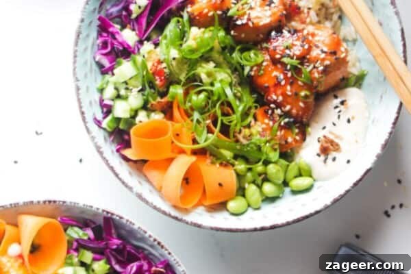 Mediterranean Ground Beef and Rice Bowls with Feta & Herbs 15 Two baked salmon poke bowls on a marble background with honey on the side.