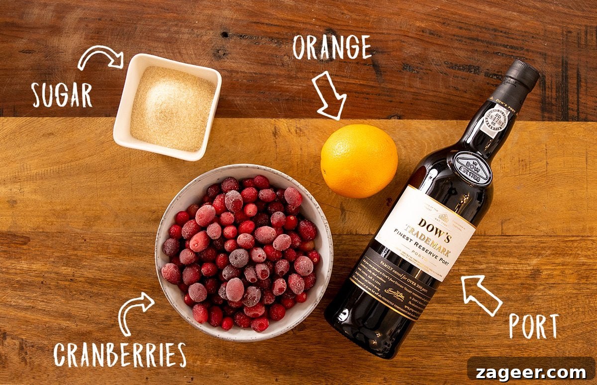 Port-Infused Cranberry Sauce Recipe for Holiday Menus 3 Ingredients for cranberry sauce on a wooden table.