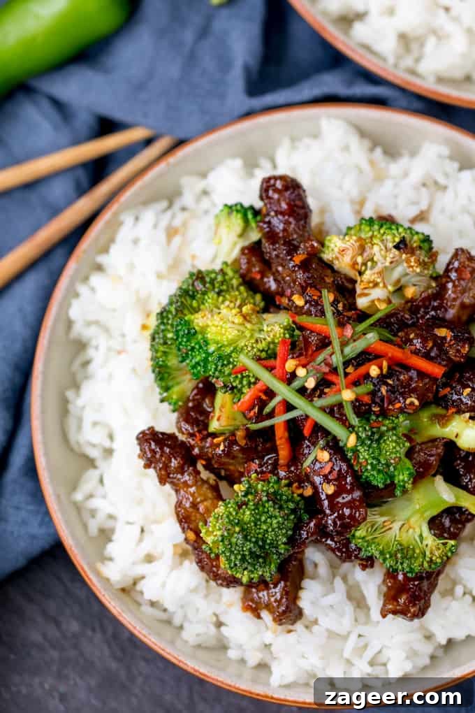 Crispy Tangy Beef with Broccoli in Sweet Glaze 5 Crispy beef strips with broccoli on a bed of boiled rice.