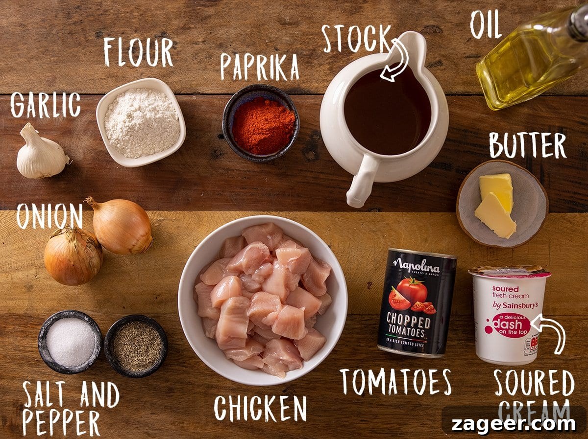 Classic Hungarian Chicken Paprikash Recipe — Creamy Paprika Chicken 4 Ingredients for chicken paprikash on a wooden table.