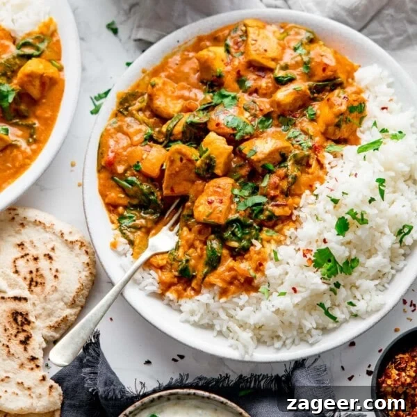Creamy Chicken Pasanda Recipe: Aromatic Mughlai Curry Guide 19 Chicken curry in a white bowl with rice.