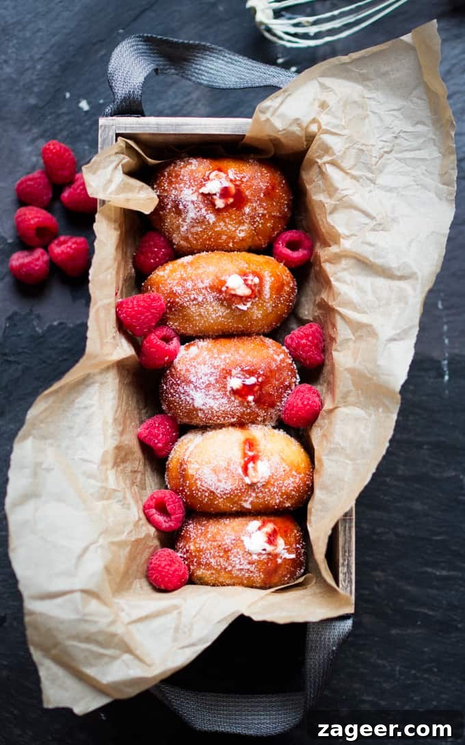 Raspberry Ripple Doughnuts Recipe: Soft Yeast Donuts with Swirl Glaze 2 Raspberry Ripple Doughnuts - Golden brown, sugar dusted and served slightly warm - filled with raspberry jam and sweetened cream. Irresistible!