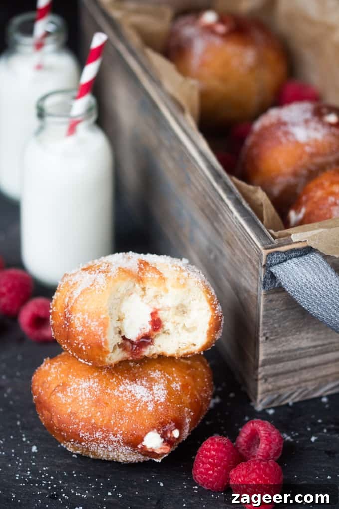 Raspberry Ripple Doughnuts Recipe: Soft Yeast Donuts with Swirl Glaze 3 Raspberry Ripple Doughnuts - Golden brown, sugar dusted and served slightly warm - filled with raspberry jam and sweetened cream. Irresistible!