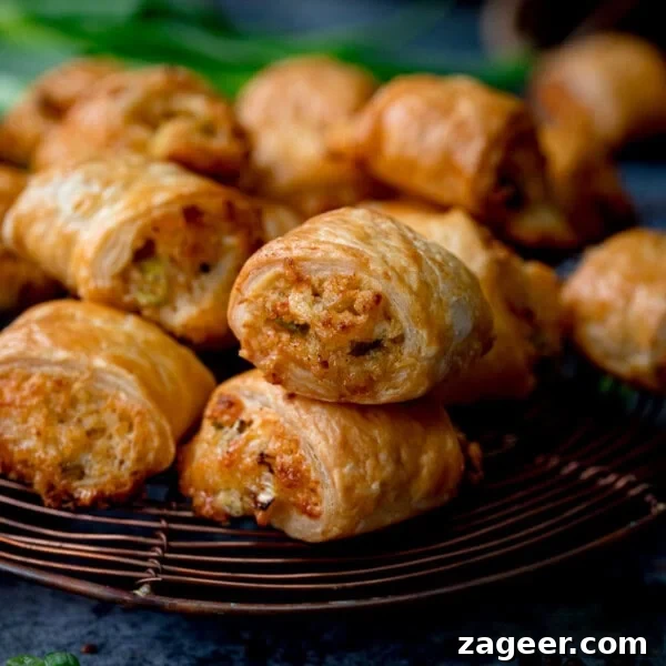 Chip Shop-Style Individual Cheese and Onion Pies 11 A close-up of golden-brown vegetarian sausage rolls