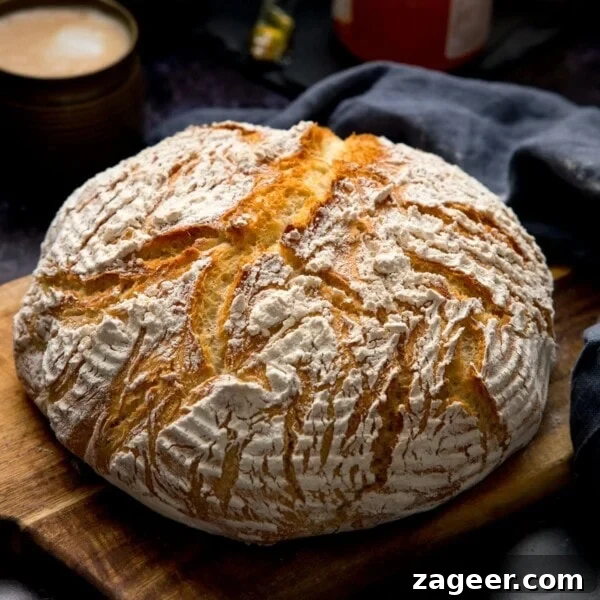 20-Minute Chorizo and Butterbean Soup Recipe 7 Square image of a round loaf of bread on a wooden board