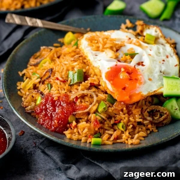 Authentic Lamb Kofta Recipe with Tangy Yogurt Sauce 9 nasi goreng rice on a plate, topped with a fried egg and sweet chilli sauce