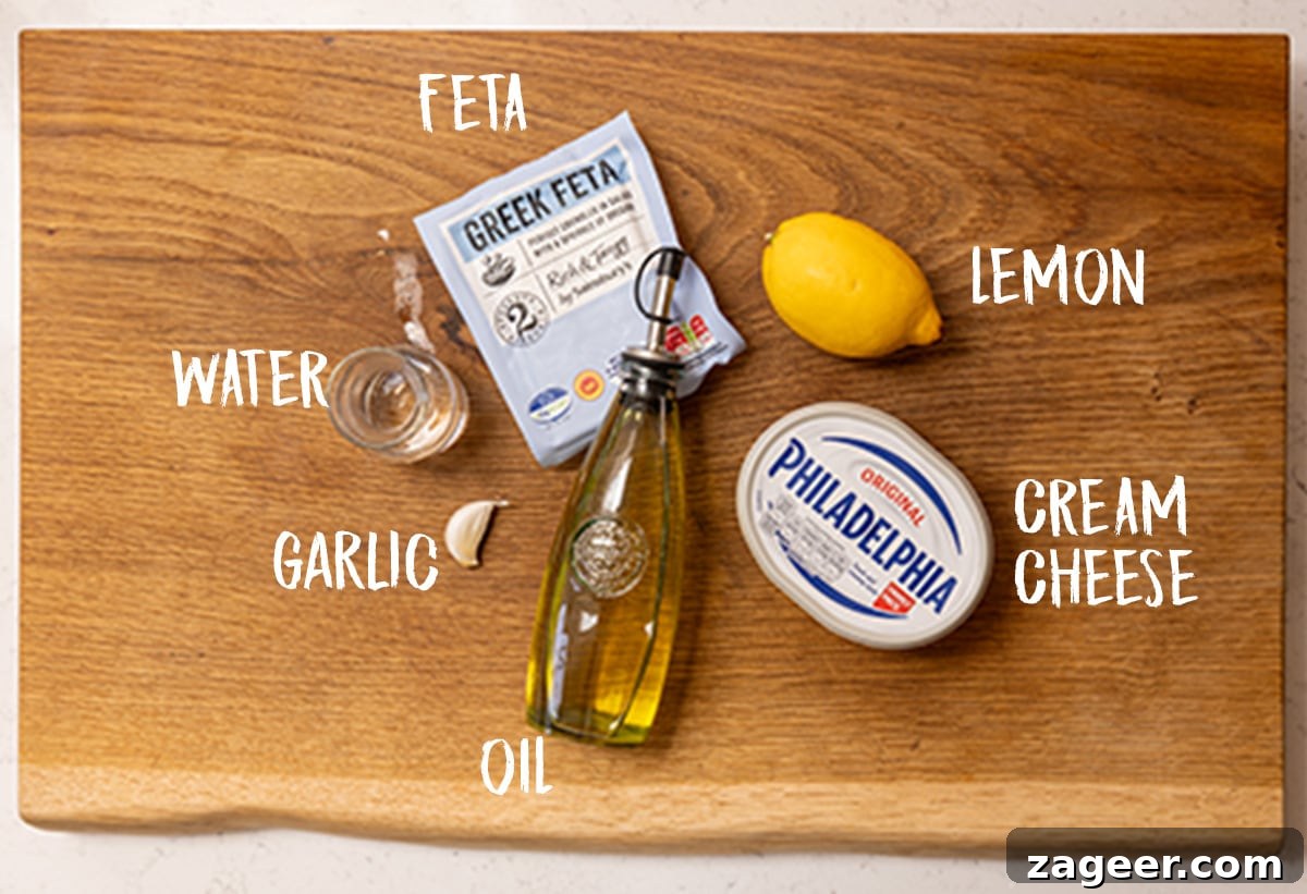 Authentic Lamb Kofta Recipe with Tangy Yogurt Sauce 4 Ingredients for whipped feta on a wooden board.