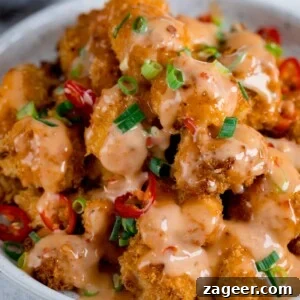 Sichuan Bang Bang Chicken Salad Recipe: Spicy Sesame Chicken 6 Bang Bang Chicken in a white bowl topped with chillies and spring onions