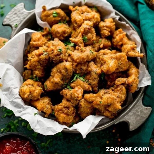 Sichuan Bang Bang Chicken Salad Recipe: Spicy Sesame Chicken 7 chicken pakoras in a bowl next to a green napkin