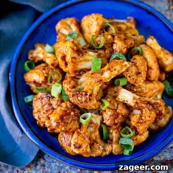Crispy Bang Bang Cauliflower with Spicy Creamy Sauce 11 Square photo of Asian cauliflower wings on a blue plate