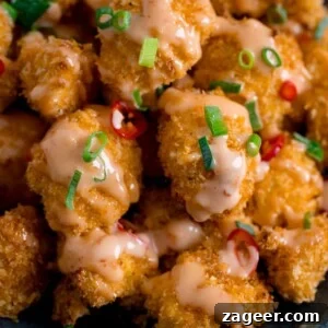 Crispy Bang Bang Cauliflower with Spicy Creamy Sauce 12 Close up of Crispy Cauliflower with bang bang sauce topped with chillies and spring onions