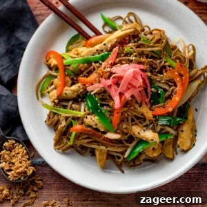 Chicken Yakisoba Recipe: Flavorful Stir-Fried Noodles with Veggies 12 a square image of chicken yakisoba on a white plate with some chopsticks on the side