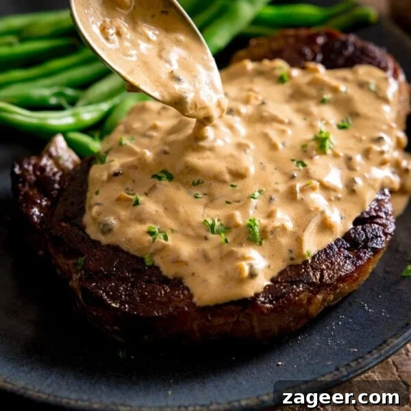 Creamy Mushroom Sauce Recipe for Pasta, Steak & Chicken 9 A cooked steak with peppercorn sauce being poured