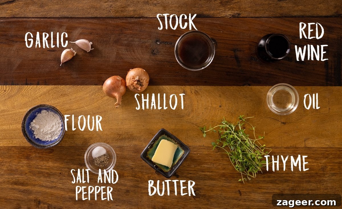 Rich Red Wine Jus Recipe for Steaks and Roasts 3 A wooden table with all of the ingredients laid out separately and labelled