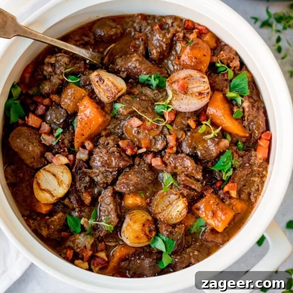 Rich Red Wine Jus Recipe for Steaks and Roasts 7 A white pot filled with beef bourguignon