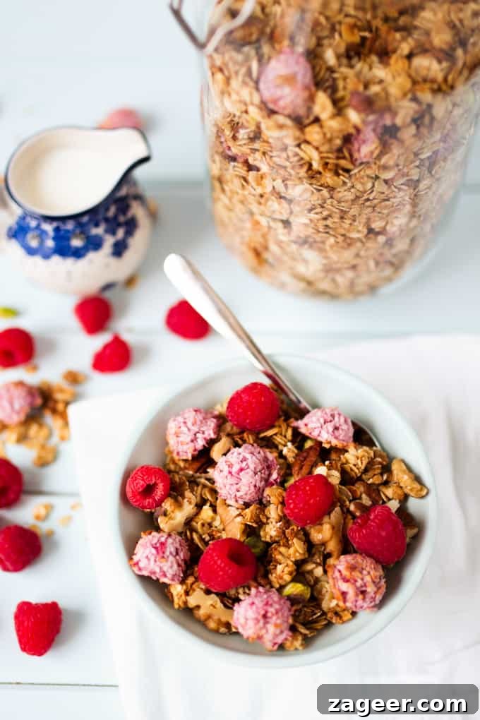 Raspberry Macaroon Granola Recipe — Coconut & Almond Clusters 2 Bowl full of coconut oil granola topped with super-quick, fresh raspberry macaroons.