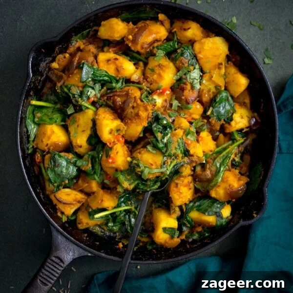 Perfect Baked Potato: Tips, Timing, and Crispy Skin Tricks 22 saag aloo in a black pan on a dark background