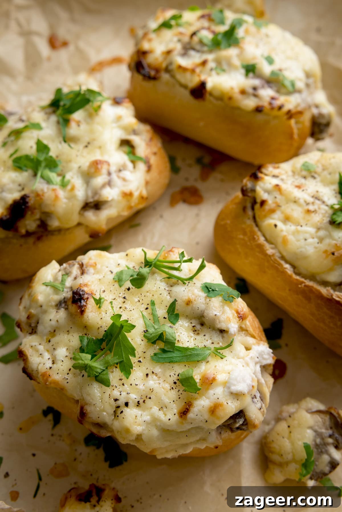 Creamy Garlic and Mushroom Stuffed Bread Rolls 2 Close up of Cheesy Mushroom Stuffed Garlic Breads topped with parsley.