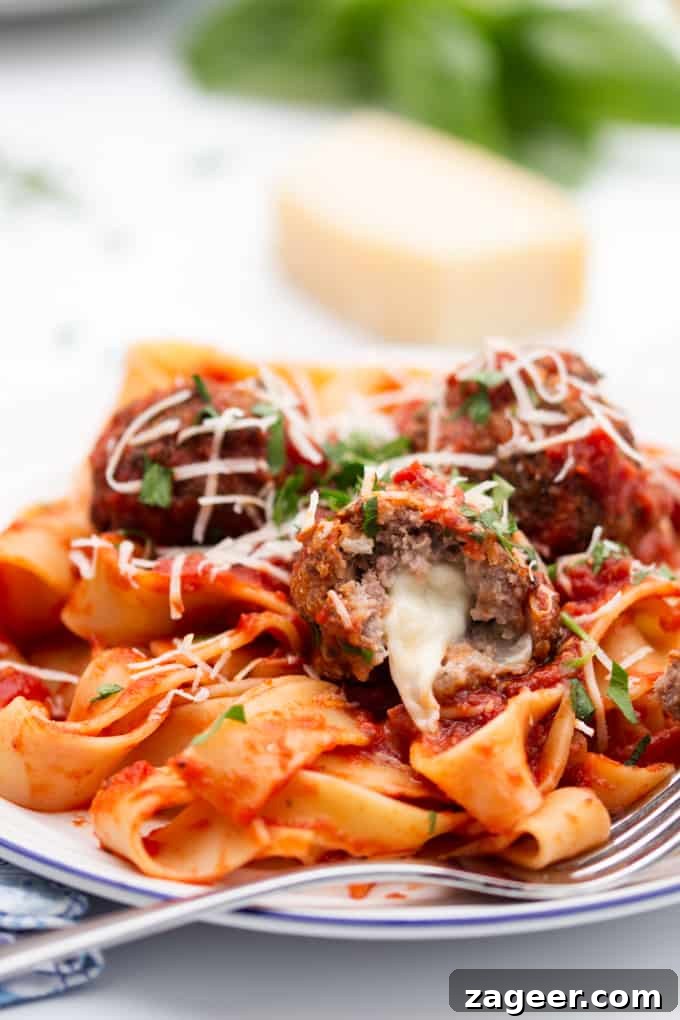 meatballs stuffed with oozy mozzarella with a rich tomato sauce and pappardelle pasta