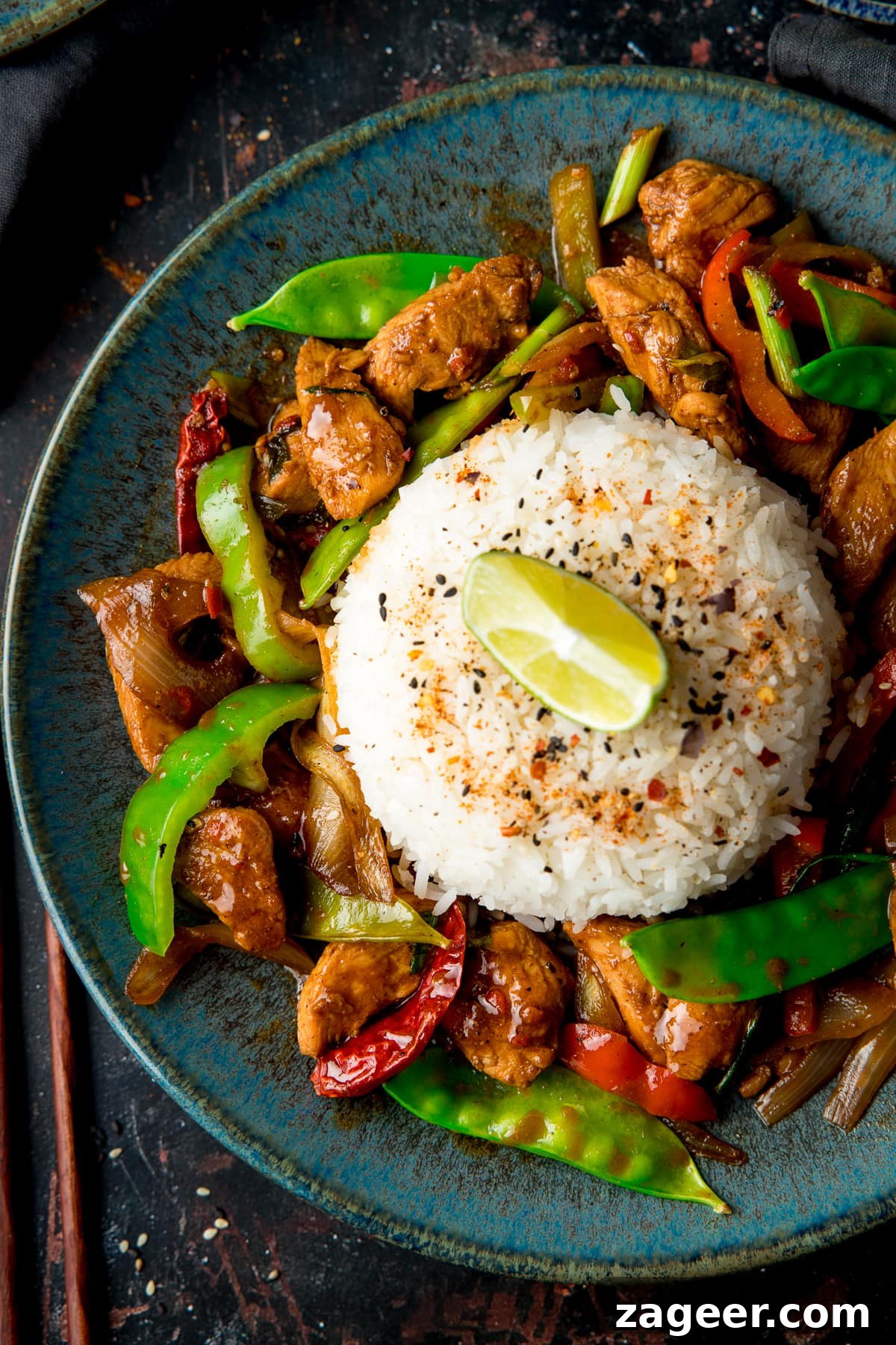 Spicy Firecracker Chicken Recipe with Crispy Bites 9 Overhead image of Firecracker chicken and rice on a blue plate