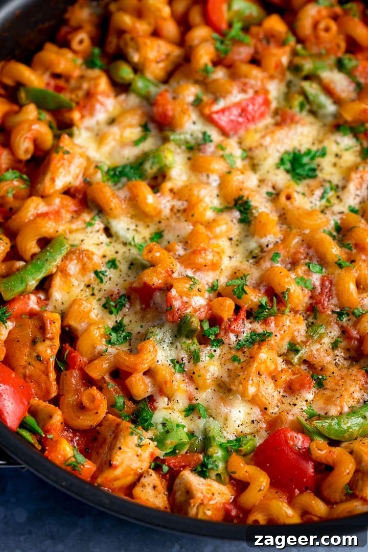 30-Minute One-Pot Chicken Pasta Recipe for Busy Weeknights 7 Close up of cheesy tomato chicken pasta in a pan