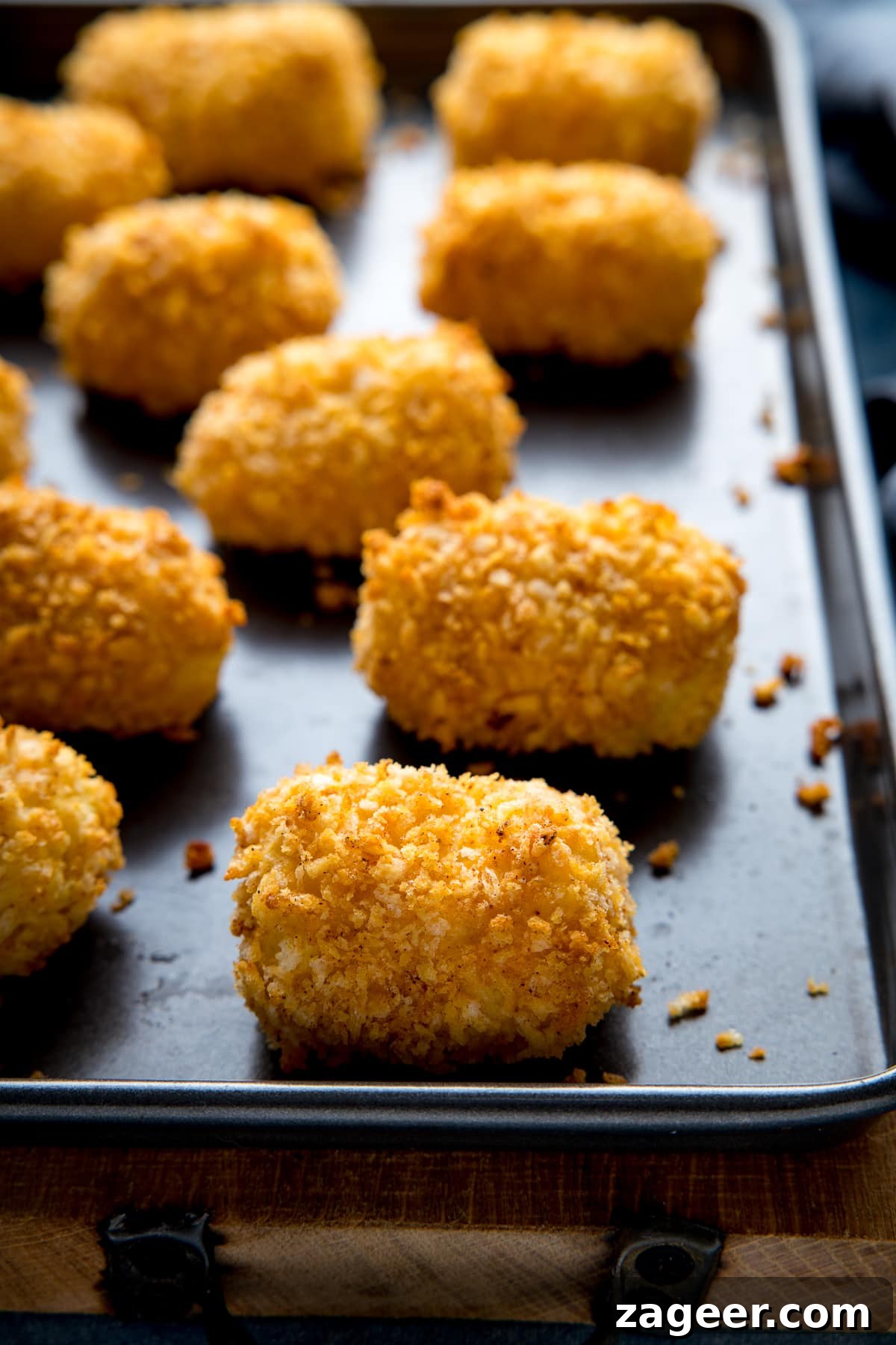 Cheesy Baked Potato Croquettes: Crispy Oven-Baked Recipe 3 potato croquettes on a baking tray