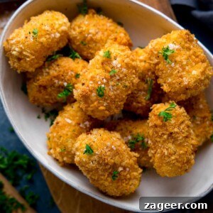 Cheesy Baked Potato Croquettes: Crispy Oven-Baked Recipe 7 Close up image of potato croquettes in a white bowl sprinkled with parsely