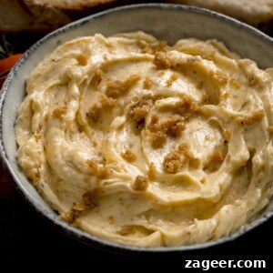 Crispy Chicken Skin Cracklings with Savory Butter Dip 14 Square image of chicken skin butter in a grey bowl